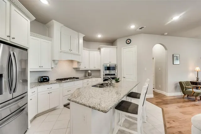 a dining room with furniture a potted plant and chandelier