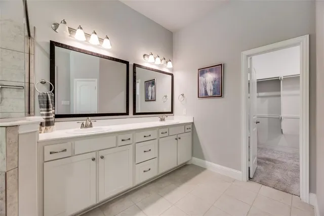 a spacious bathroom with a double vanity sink mirror and double