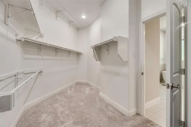 a utility room with granite countertop cabinets washer and dryer
