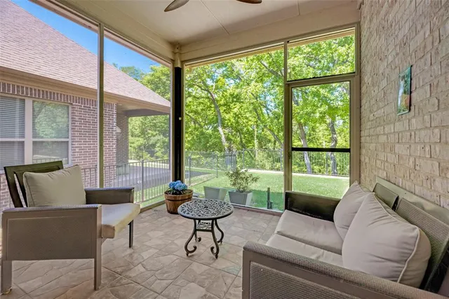 a view of a field with large trees