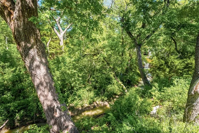 an aerial view of residential houses with outdoor space and swimming pool