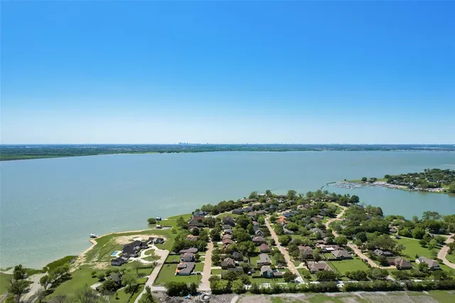 an aerial view of a house with a yard and large tree