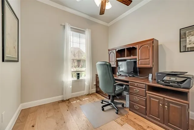 a living room with couches and kitchen view with wooden floor