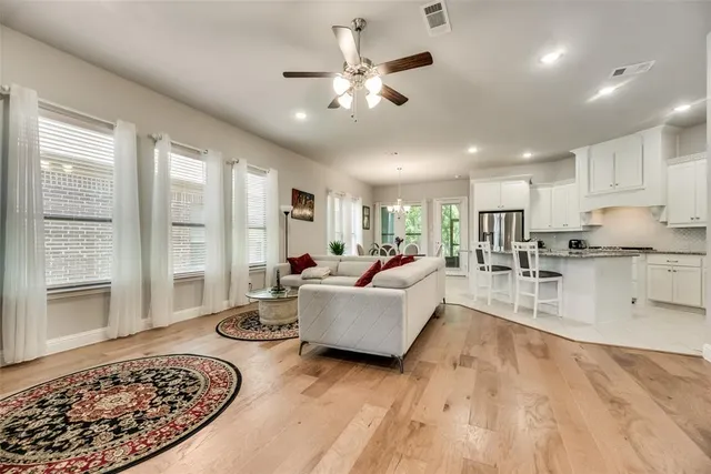 a living room with furniture and a chandelier