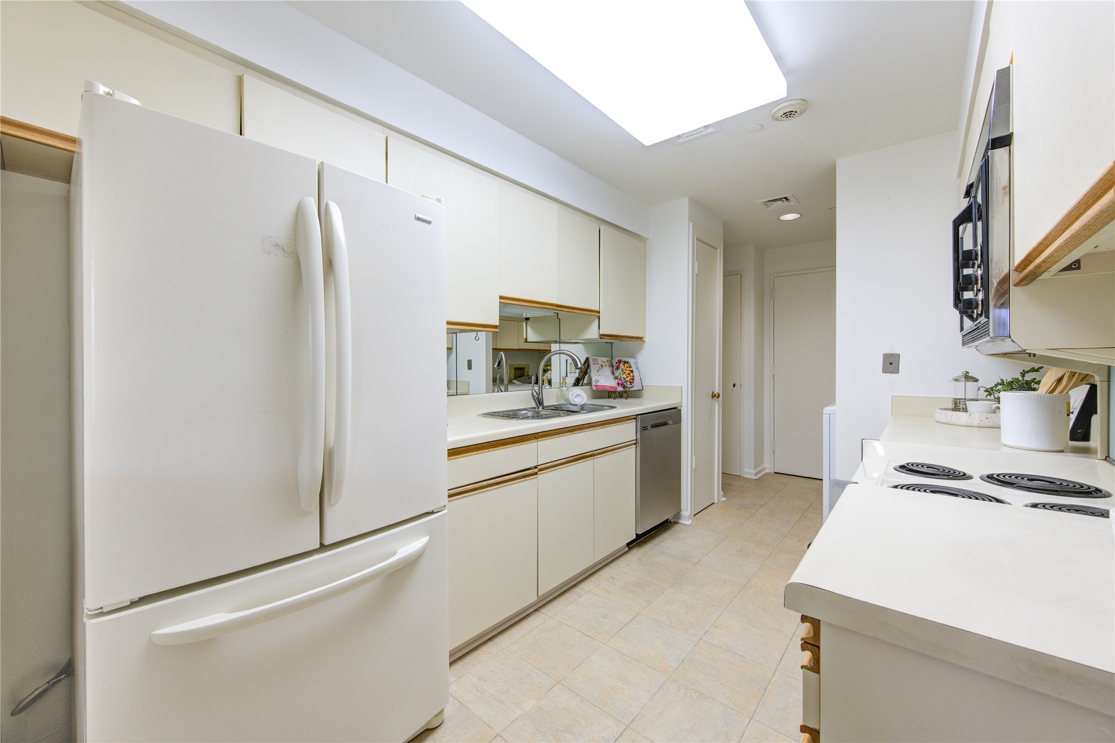 150 Gessner Road, Unit 5A Houston, TX 77024 - Photo 15 of 36 a kitchen with stainless steel appliances a refrigerator sink and stove