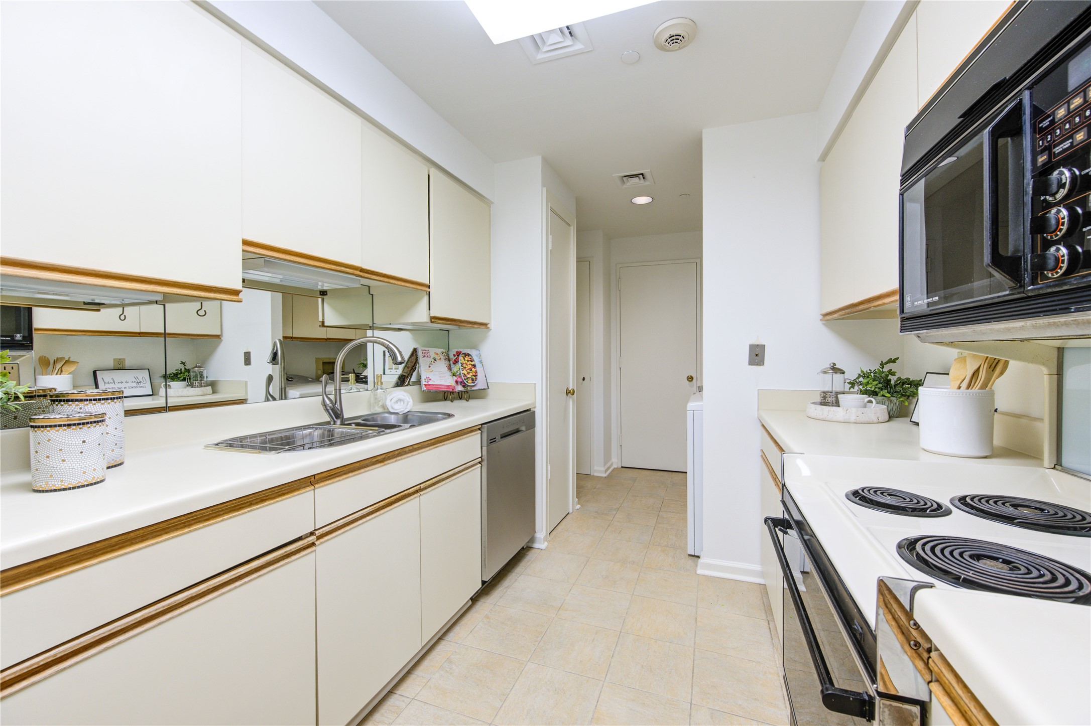 150 Gessner Road, Unit 5A Houston, TX 77024 - Photo 16 of 36 a kitchen with sink stove and cabinets