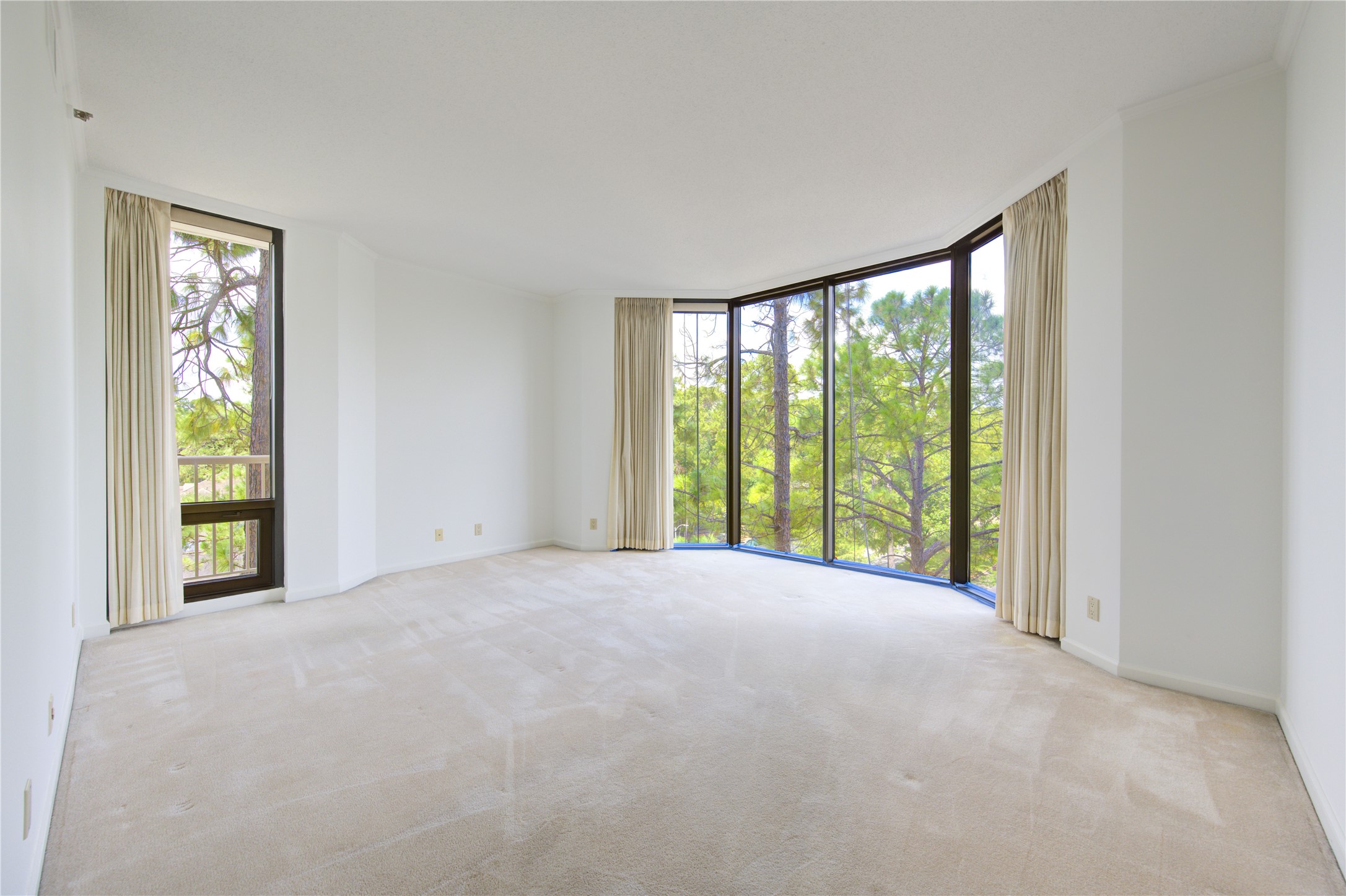 150 Gessner Road, Unit 5A Houston, TX 77024 - Photo 18 of 36 a view of an empty room with a large window and front door