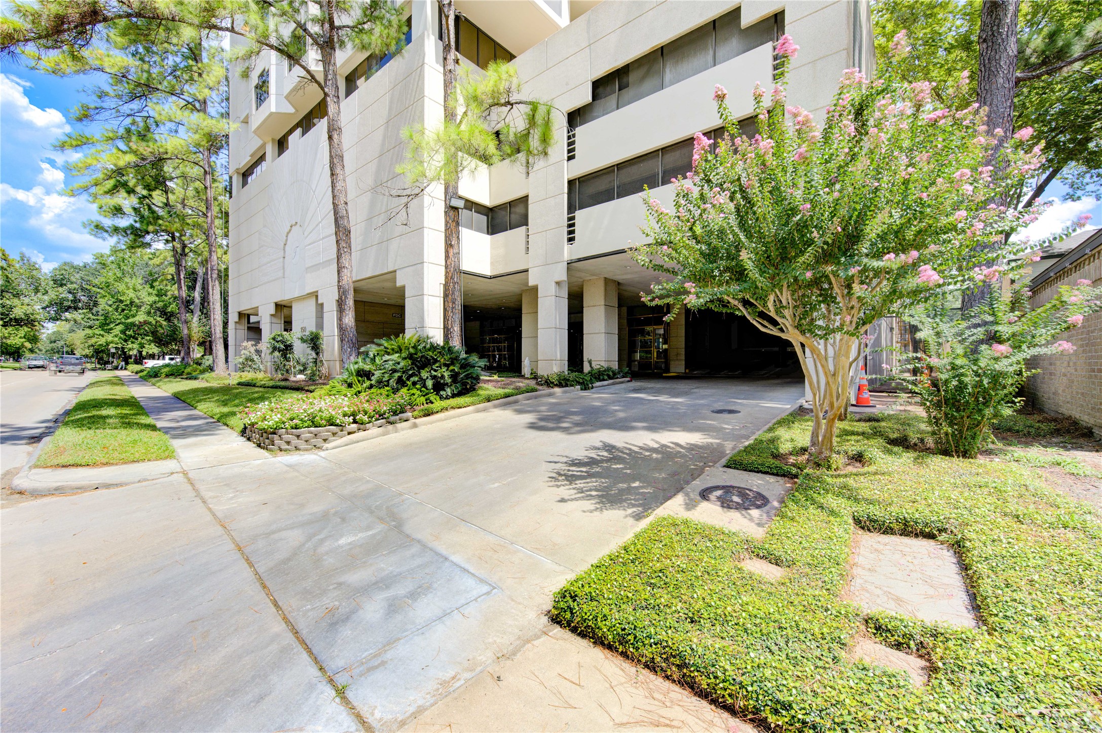 150 Gessner Road, Unit 5A Houston, TX 77024 - Photo 32 of 36 a view of a building with a yard and potted plants