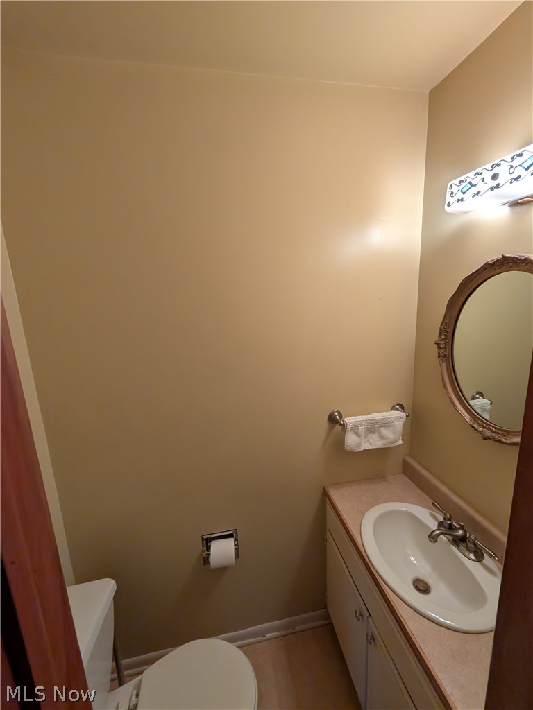 1161 Gulf Road Elyria, OH 44035 - Photo 13 of 34 Compact powder room featuring a single vanity with an integral sink, a countertop, and base cabinetry