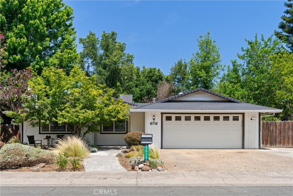 3030 Silverbell Road Chico, CA 95973 - Photo 1 of 42 a front view of a house with a garden and mountain