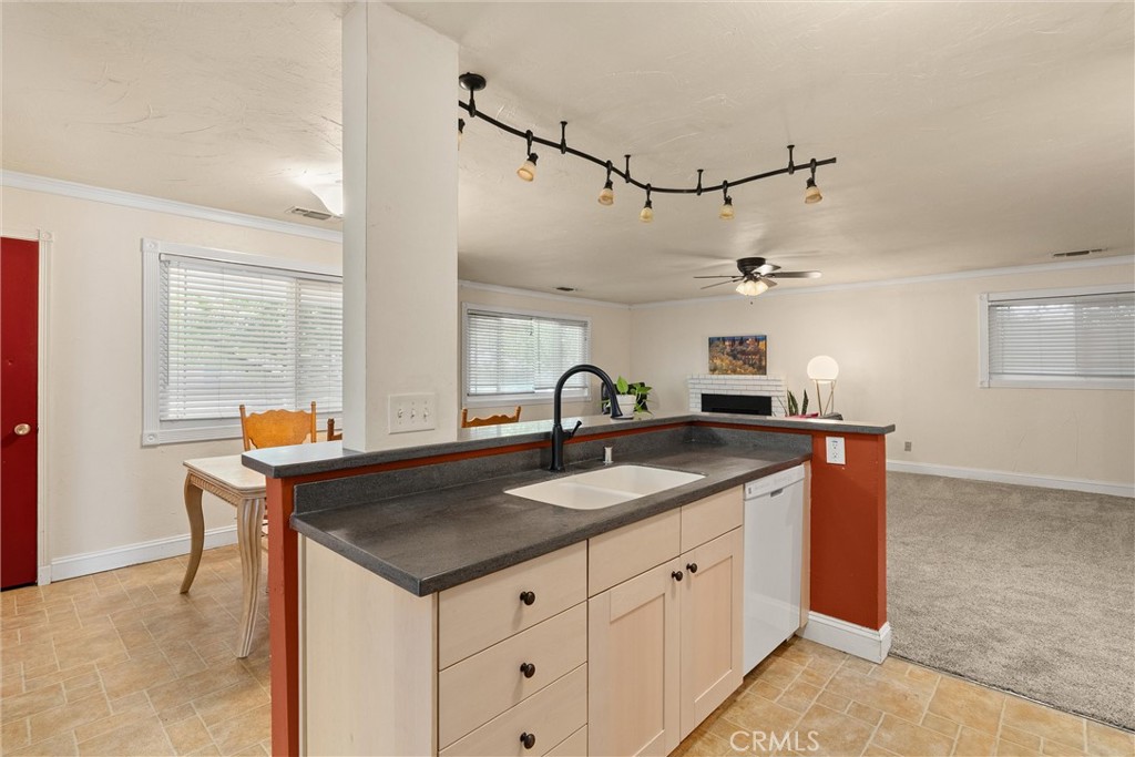 3030 Silverbell Road Chico, CA 95973 - Photo 24 of 42 a kitchen with granite countertop a sink and white cabinets