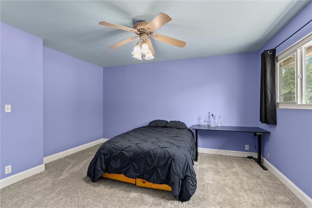 3030 Silverbell Road Chico, CA 95973 - Photo 29 of 42 a bedroom with a bed and a ceiling fan