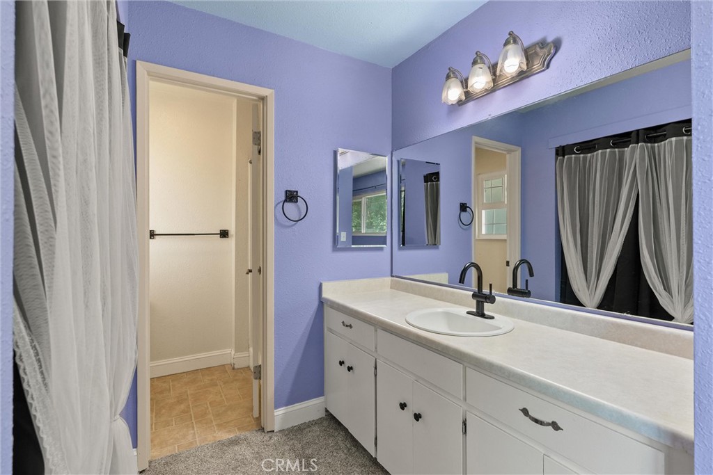 3030 Silverbell Road Chico, CA 95973 - Photo 31 of 42 a bathroom with a sink vanity and a mirror