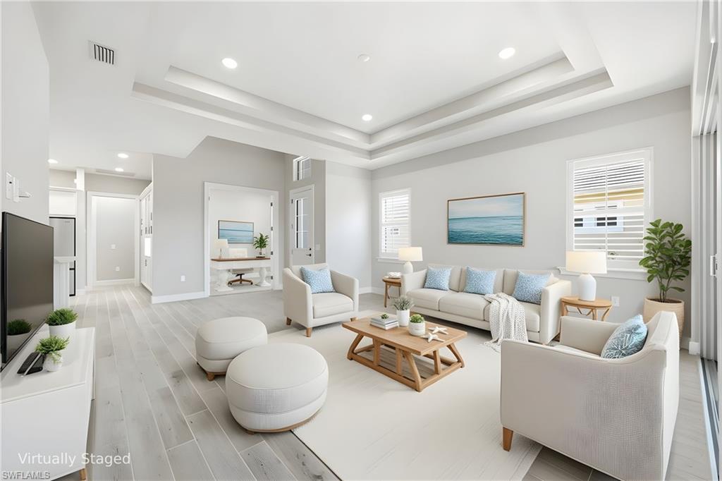 8937 Calypso Court Naples, FL 34113 - Photo 11 of 43 a living room with furniture and a flat screen tv