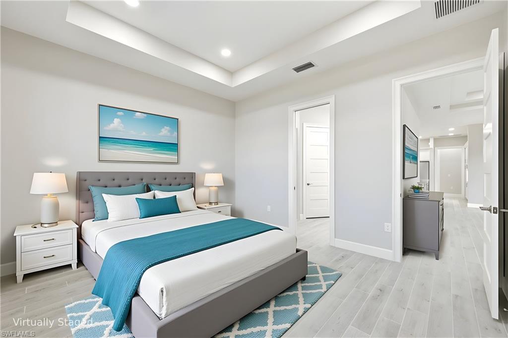 8937 Calypso Court Naples, FL 34113 - Photo 12 of 43 a bedroom with a bed and a painting