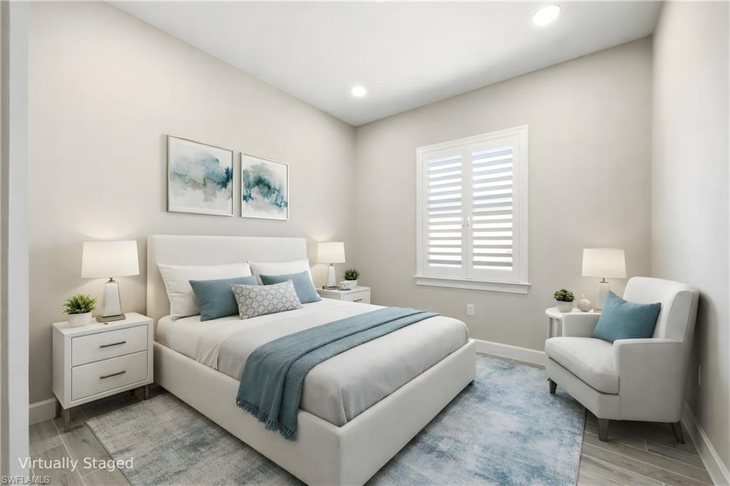 8937 Calypso Court Naples, FL 34113 - Photo 16 of 43 a bedroom with bed and a couch