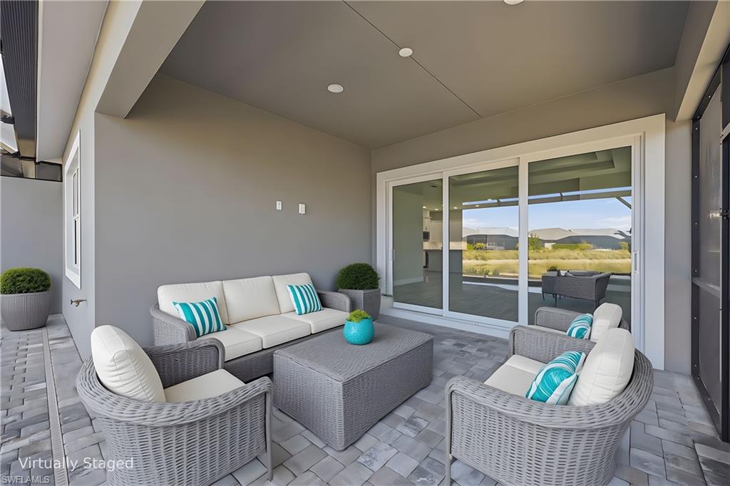 8937 Calypso Court Naples, FL 34113 - Photo 18 of 43 a living room with furniture and a window