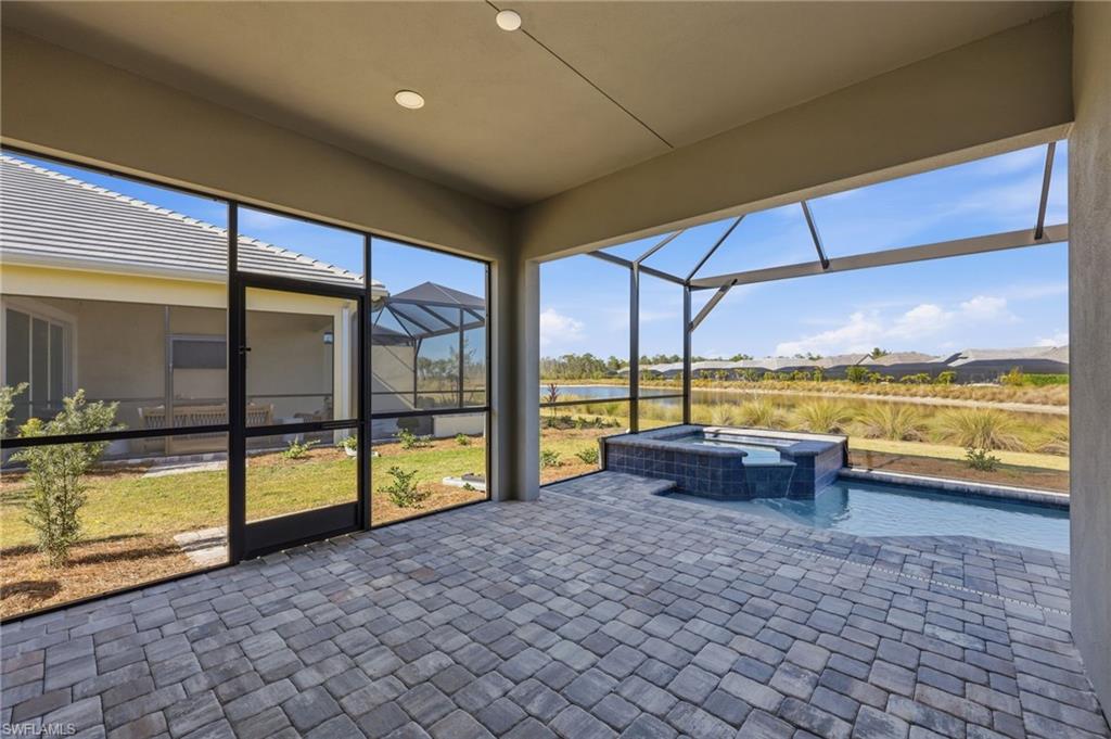 8937 Calypso Court Naples, FL 34113 - Photo 21 of 43 a view of a swimming pool and an outdoor seating