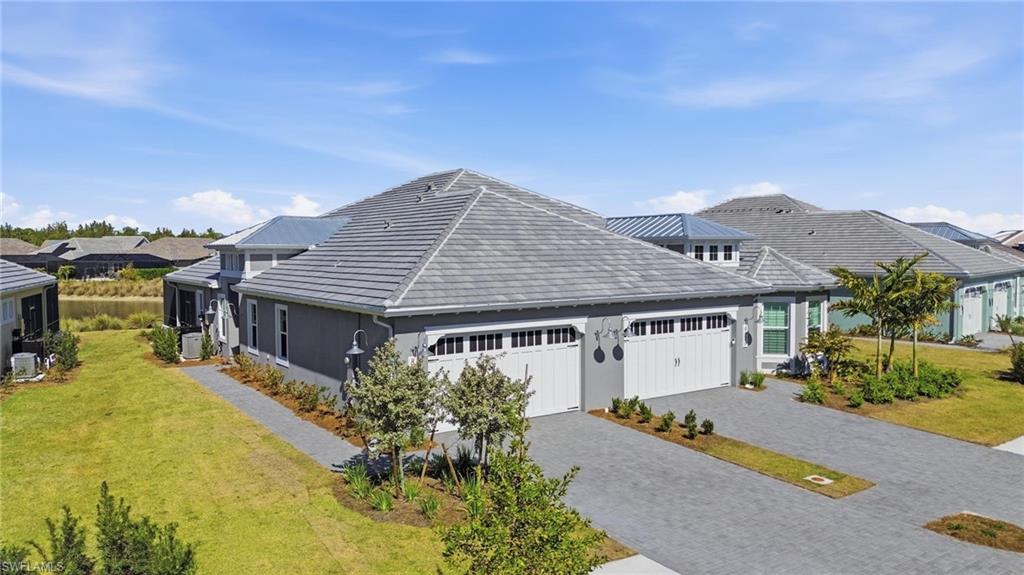 8937 Calypso Court Naples, FL 34113 - Photo 24 of 43 a house with a large pool in front of it