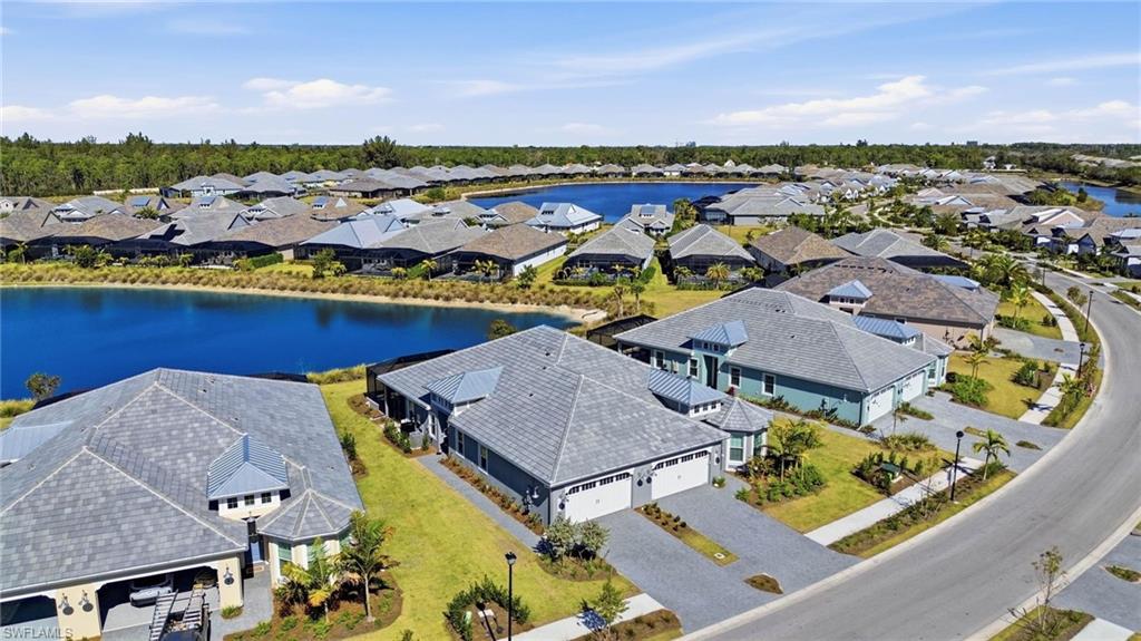 8937 Calypso Court Naples, FL 34113 - Photo 25 of 43 an aerial view of residential houses with outdoor space and ocean view