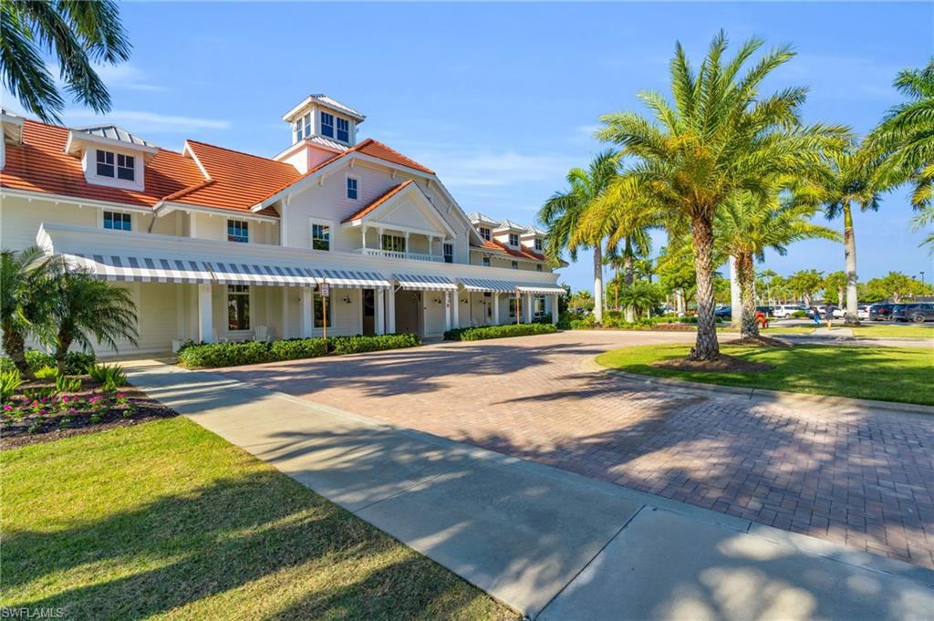 8937 Calypso Court Naples, FL 34113 - Photo 26 of 43 a front view of house with yard and green space