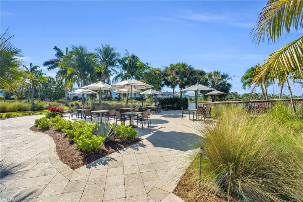 8937 Calypso Court Naples, FL 34113 - Photo 29 of 43 a view of a swimming pool with chair and table in the patio