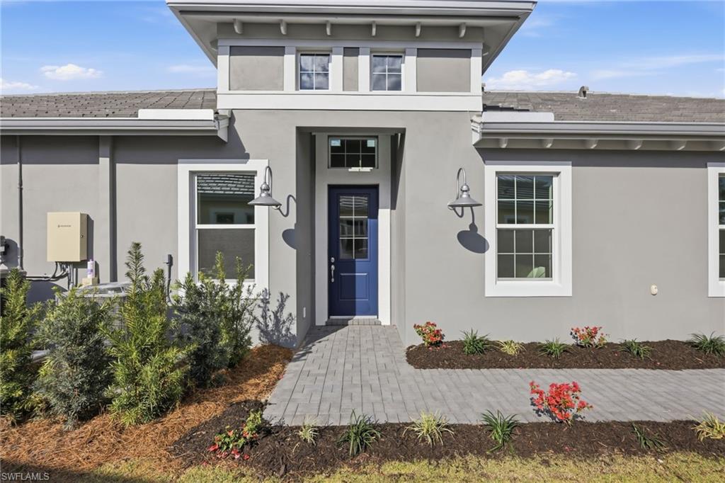 8937 Calypso Court Naples, FL 34113 - Photo 3 of 43 a front view of a house with a yard