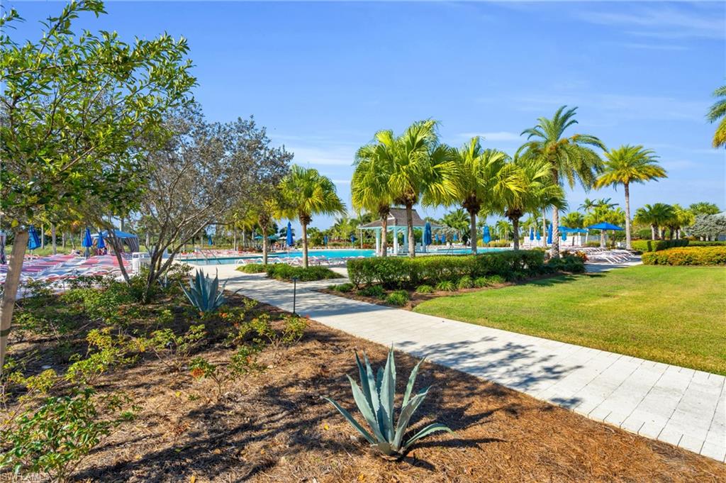 8937 Calypso Court Naples, FL 34113 - Photo 32 of 43 a front view of a house with garden