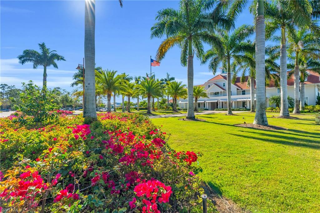 8937 Calypso Court Naples, FL 34113 - Photo 35 of 43 a view of a swimming pool with a yard and palm trees