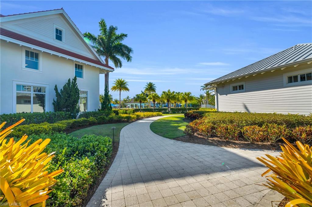 8937 Calypso Court Naples, FL 34113 - Photo 36 of 43 a front view of a house with a yard