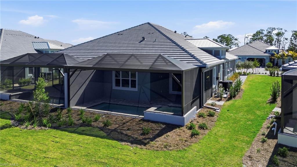 8937 Calypso Court Naples, FL 34113 - Photo 6 of 43 a front view of a house with garden