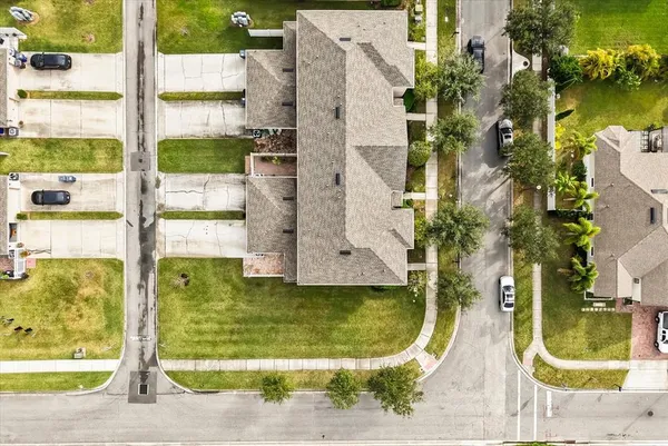 an aerial view of a residential houses with outdoor space and swimming pool