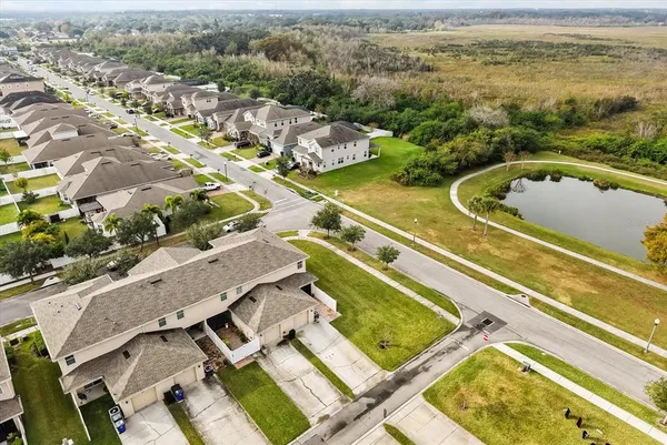 an aerial view of residential houses with outdoor space
