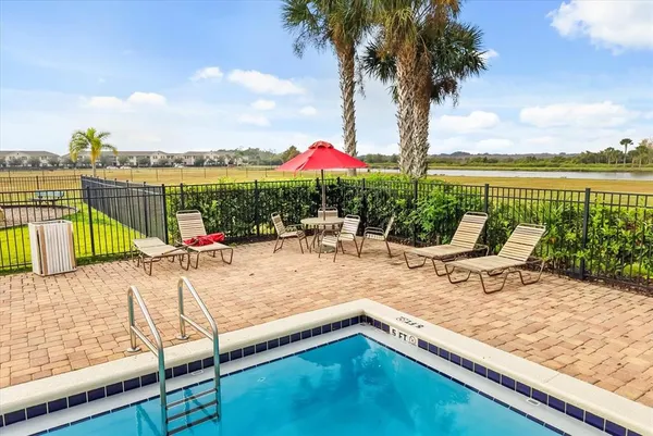 a view of swimming pool with a lounge chairs
