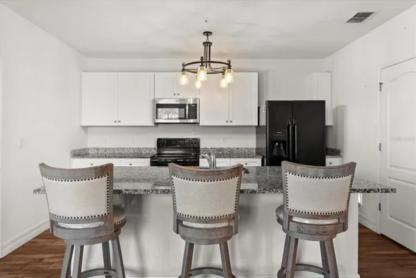 a kitchen with a table and chairs
