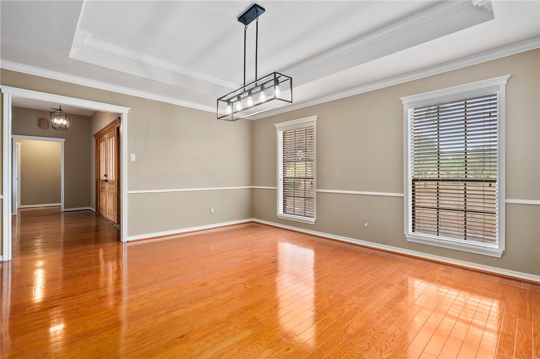 4177 Bobwhite Road Robstown, TX 78380 - Photo 12 of 32 a view of an empty room with a window and chandelier