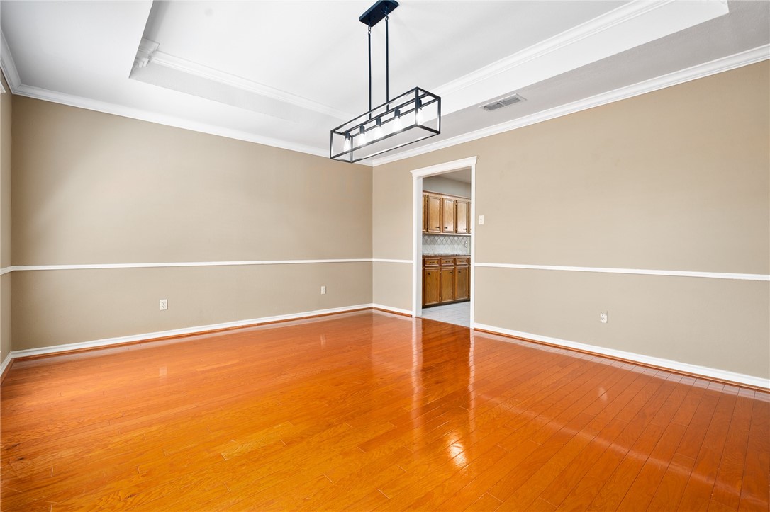 4177 Bobwhite Road Robstown, TX 78380 - Photo 13 of 32 a view of an empty room with wooden floor and a window