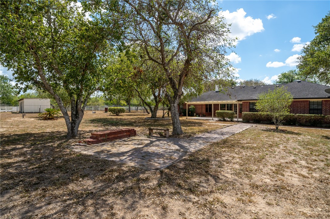 4177 Bobwhite Road Robstown, TX 78380 - Photo 29 of 32 a front view of a house with a yard