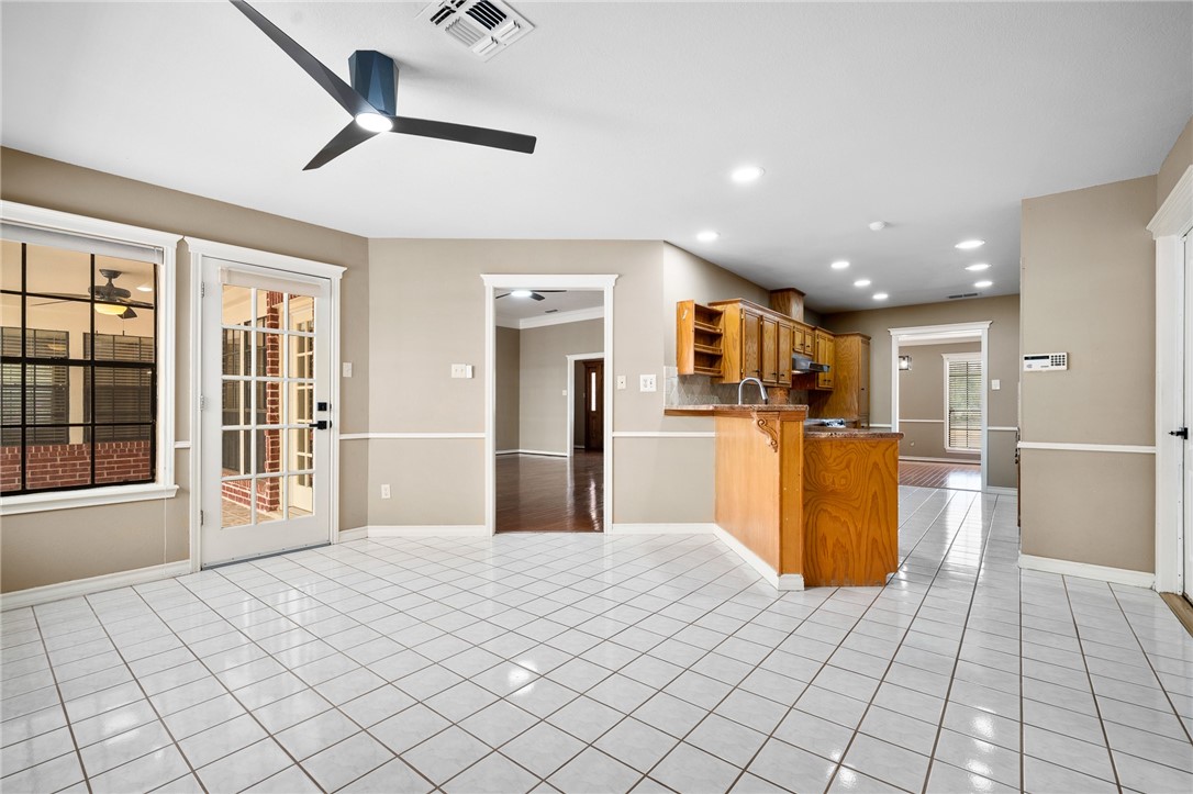 4177 Bobwhite Road Robstown, TX 78380 - Photo 8 of 32 a kitchen with stainless steel appliances kitchen island granite countertop a refrigerator and a sink