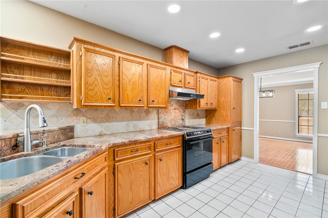 4177 Bobwhite Road Robstown, TX 78380 - Photo 9 of 32 a kitchen with stainless steel appliances granite countertop a sink and cabinets