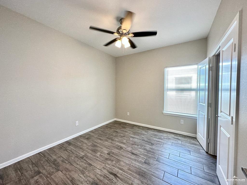 902 Starr Street Mercedes, TX 78570 - Photo 5 of 14 an empty room with wooden floor fan and windows