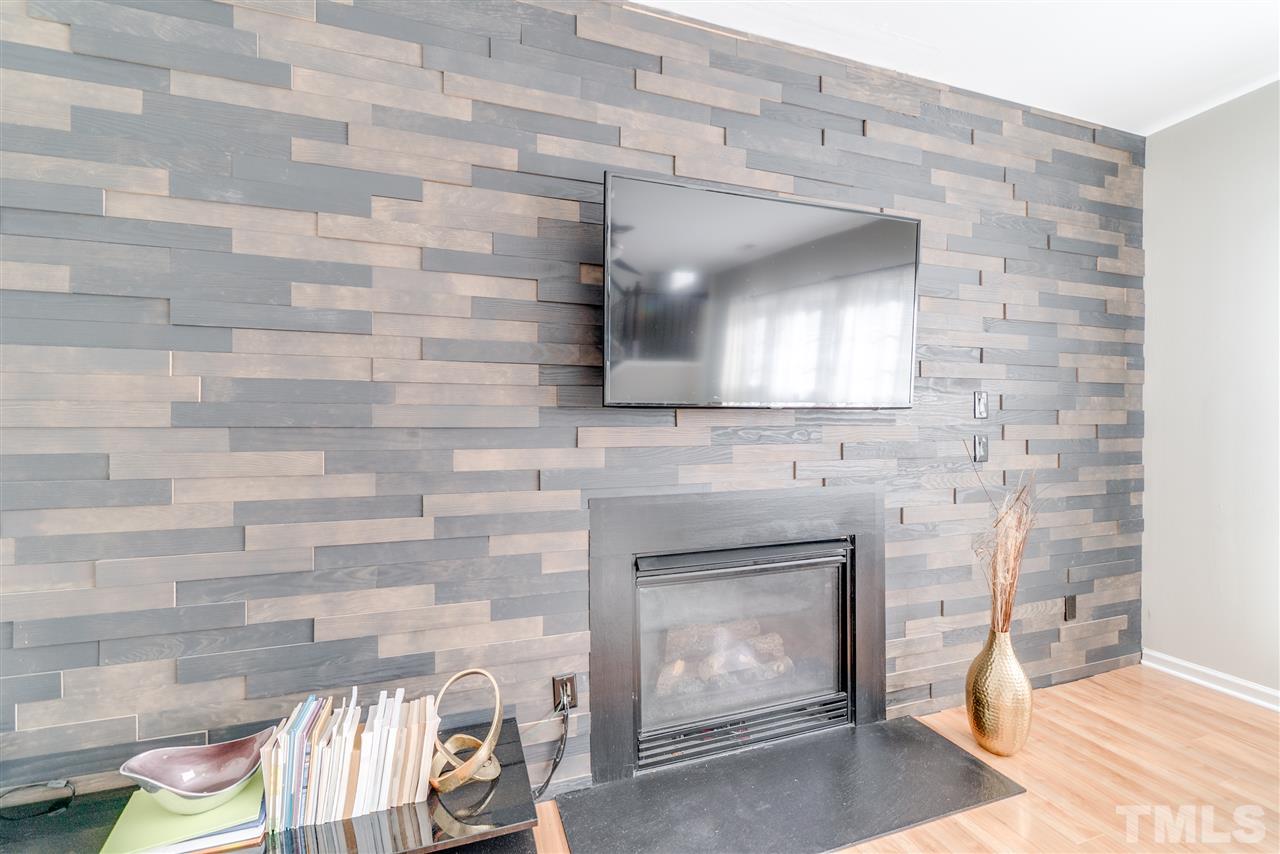 5319 Griffith Park Road Raleigh, NC 27613 - Photo 12 of 25 a living room with a fireplace and a fireplace