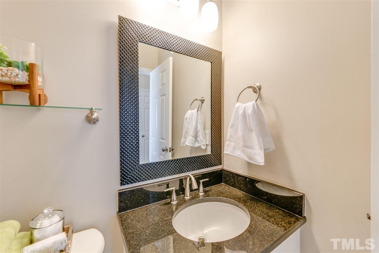 5319 Griffith Park Road Raleigh, NC 27613 - Photo 15 of 25 a bathroom with a granite countertop sink and a mirror
