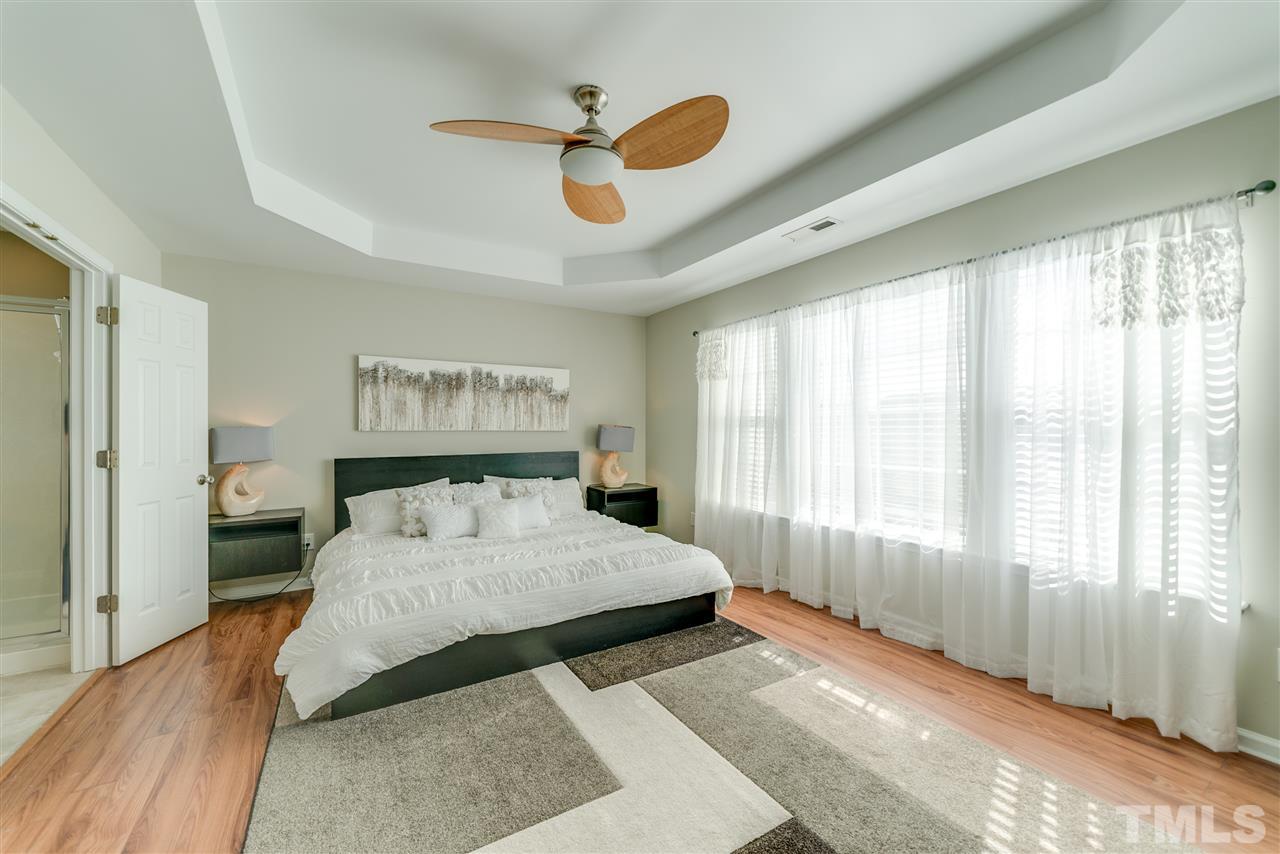 5319 Griffith Park Road Raleigh, NC 27613 - Photo 17 of 25 a bedroom with a large bed and a large window