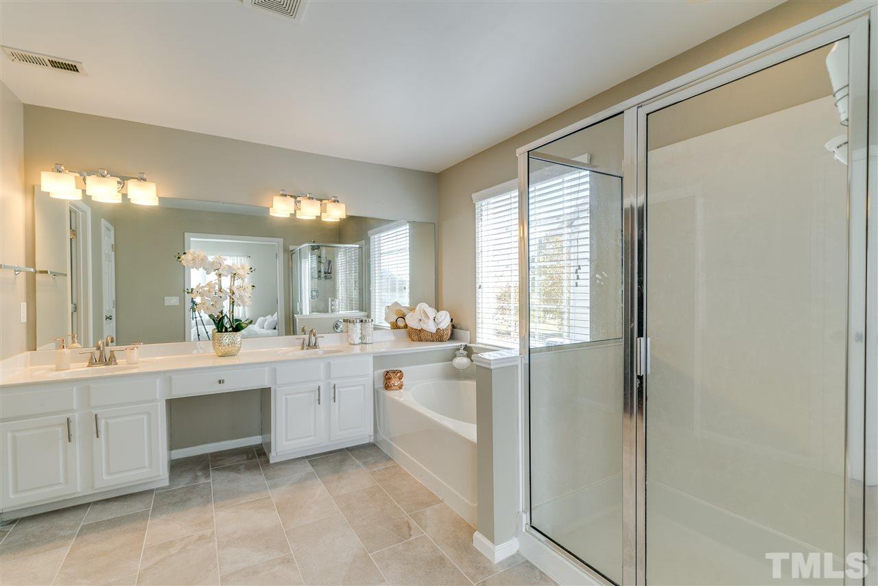 5319 Griffith Park Road Raleigh, NC 27613 - Photo 19 of 25 a large bathroom with a large mirror vanity and a sink