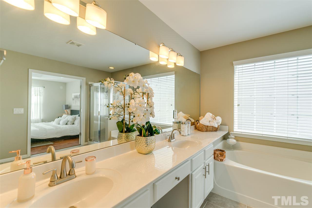 5319 Griffith Park Road Raleigh, NC 27613 - Photo 20 of 25 a bathroom with a granite countertop sink and a mirror