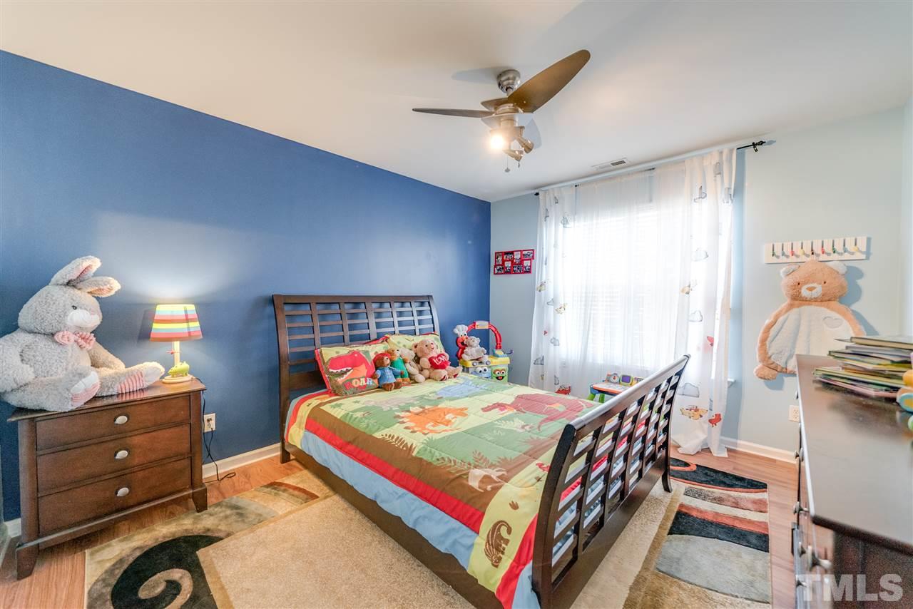5319 Griffith Park Road Raleigh, NC 27613 - Photo 21 of 25 a bedroom with a bed and wooden floor