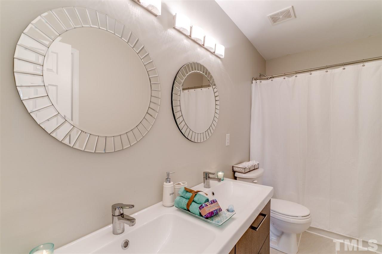 5319 Griffith Park Road Raleigh, NC 27613 - Photo 24 of 25 a bathroom with a sink and a mirror