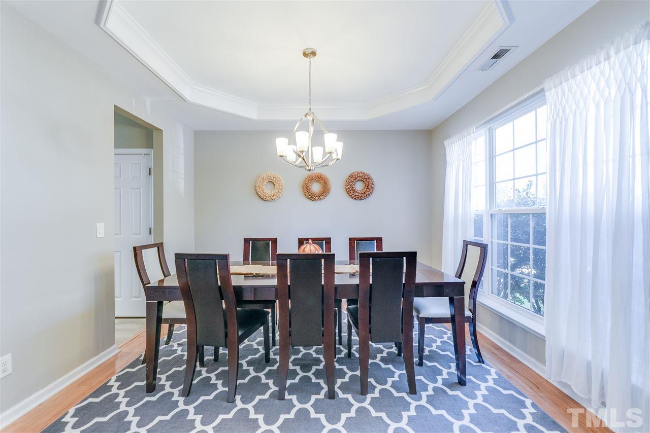 5319 Griffith Park Road Raleigh, NC 27613 - Photo 4 of 25 a view of a dining room with furniture and chandelier