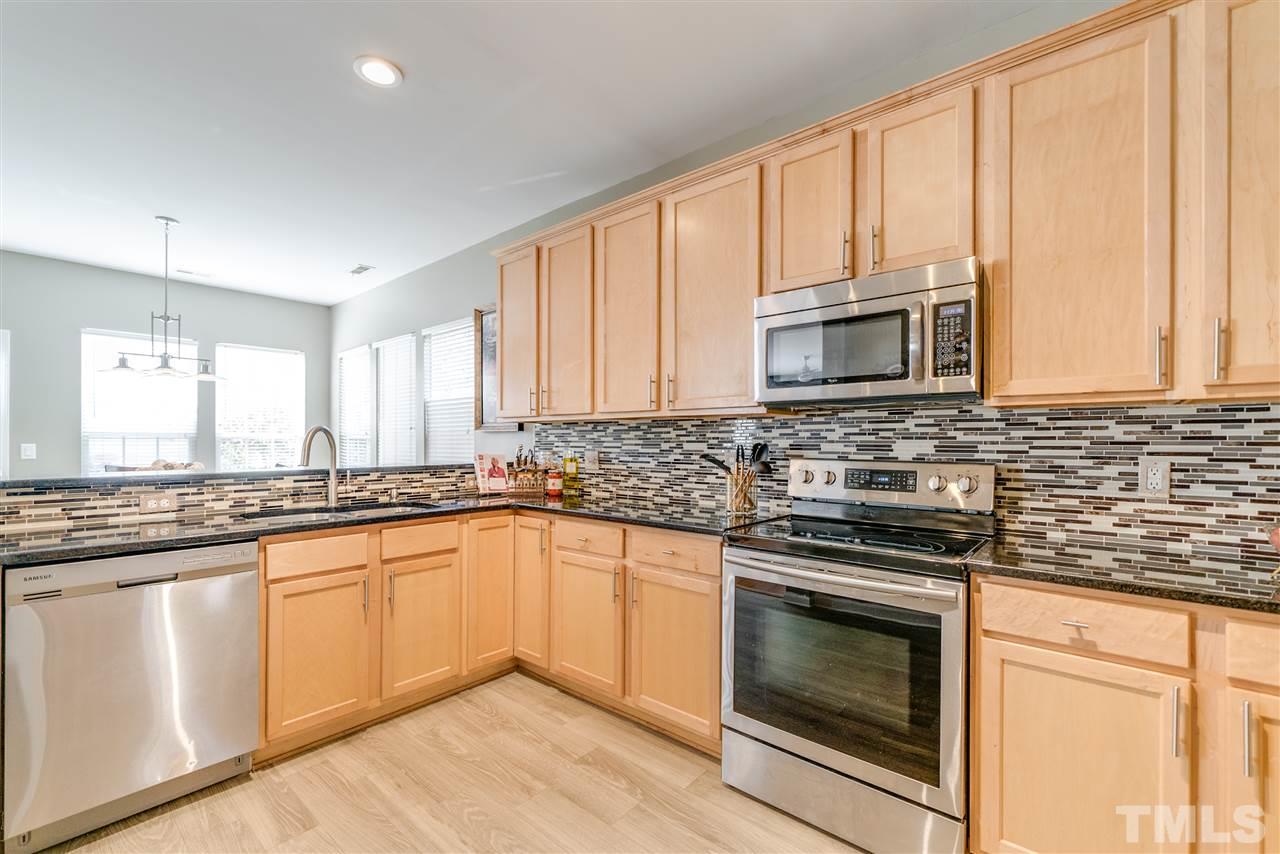 5319 Griffith Park Road Raleigh, NC 27613 - Photo 5 of 25 a kitchen with granite countertop cabinets stainless steel appliances and a sink